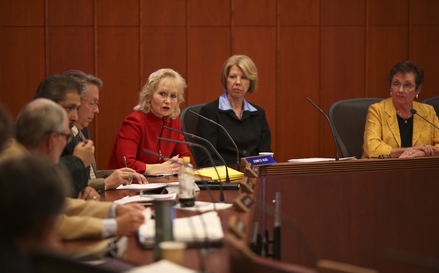 Metropolitan Council member Jennifer Munt, in red, asked fellow transportation committee member Jon Commers a question Monday.