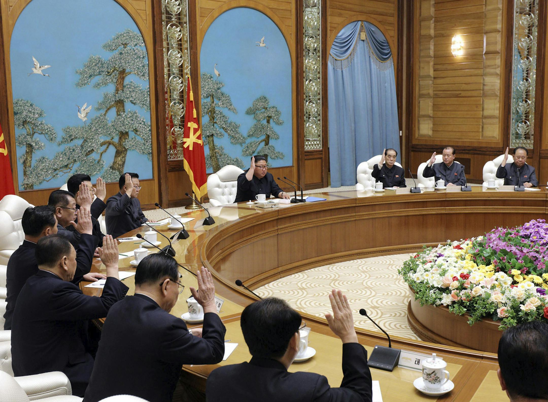 FILE - In this April 11, 2020, file photo provided by the North Korean government, North Korean leader Kim Jong Un, center top, attends a politburo meeting of the ruling Workers' Party of Korea in Pyongyang, North Korea. The South Korean government is looking into reports that North Korean leader Kim Jong Un is in fragile condition after surgery.  Officials from South Korea’s Unification Ministry and National Intelligence Service couldn’t immediately confirm the reports citing