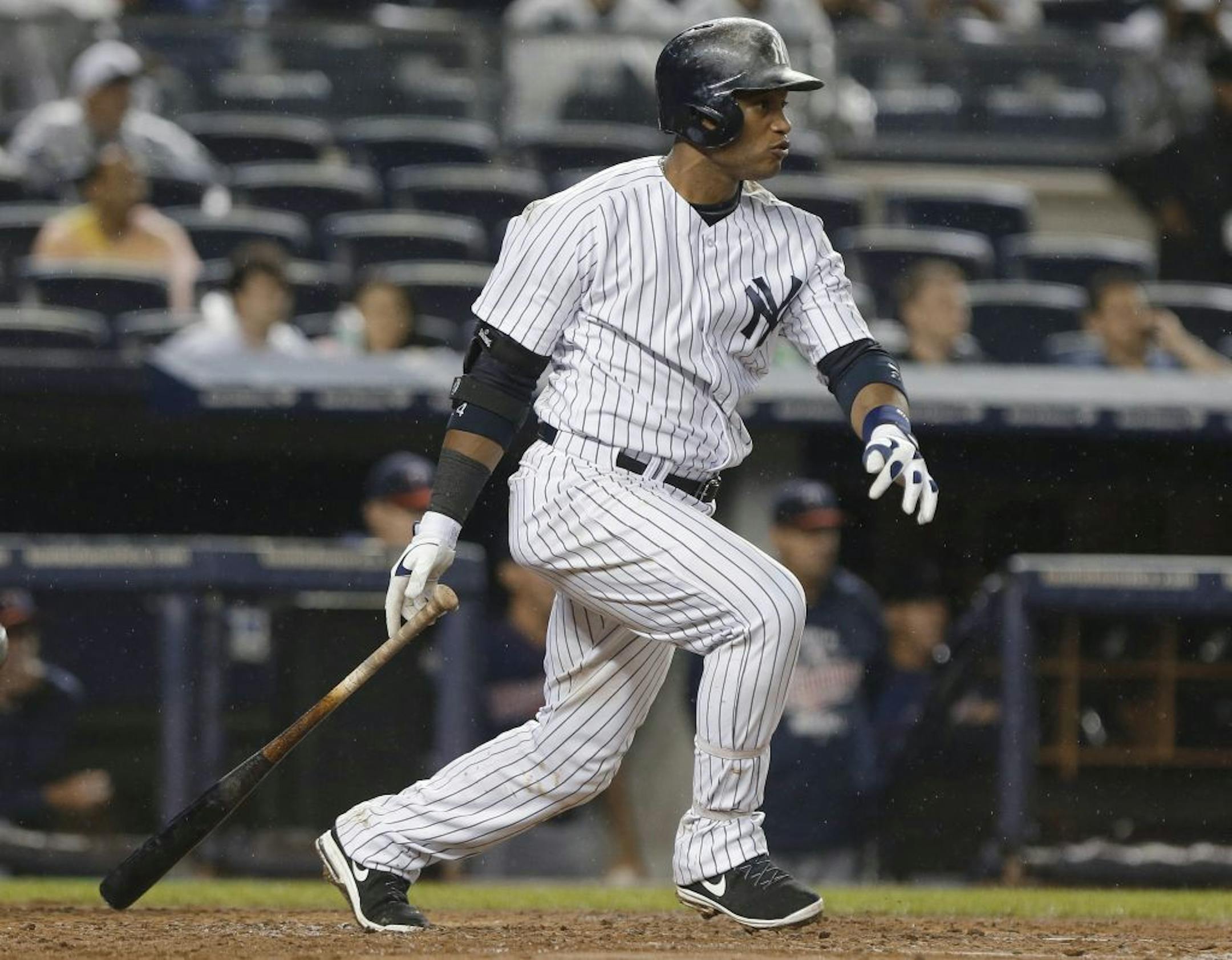 New York Yankees' Robinson Cano follows through on an RBI single during the fifth inning of a baseball game against the Minnesota Twins on Friday, July 12, 2013, in New York.