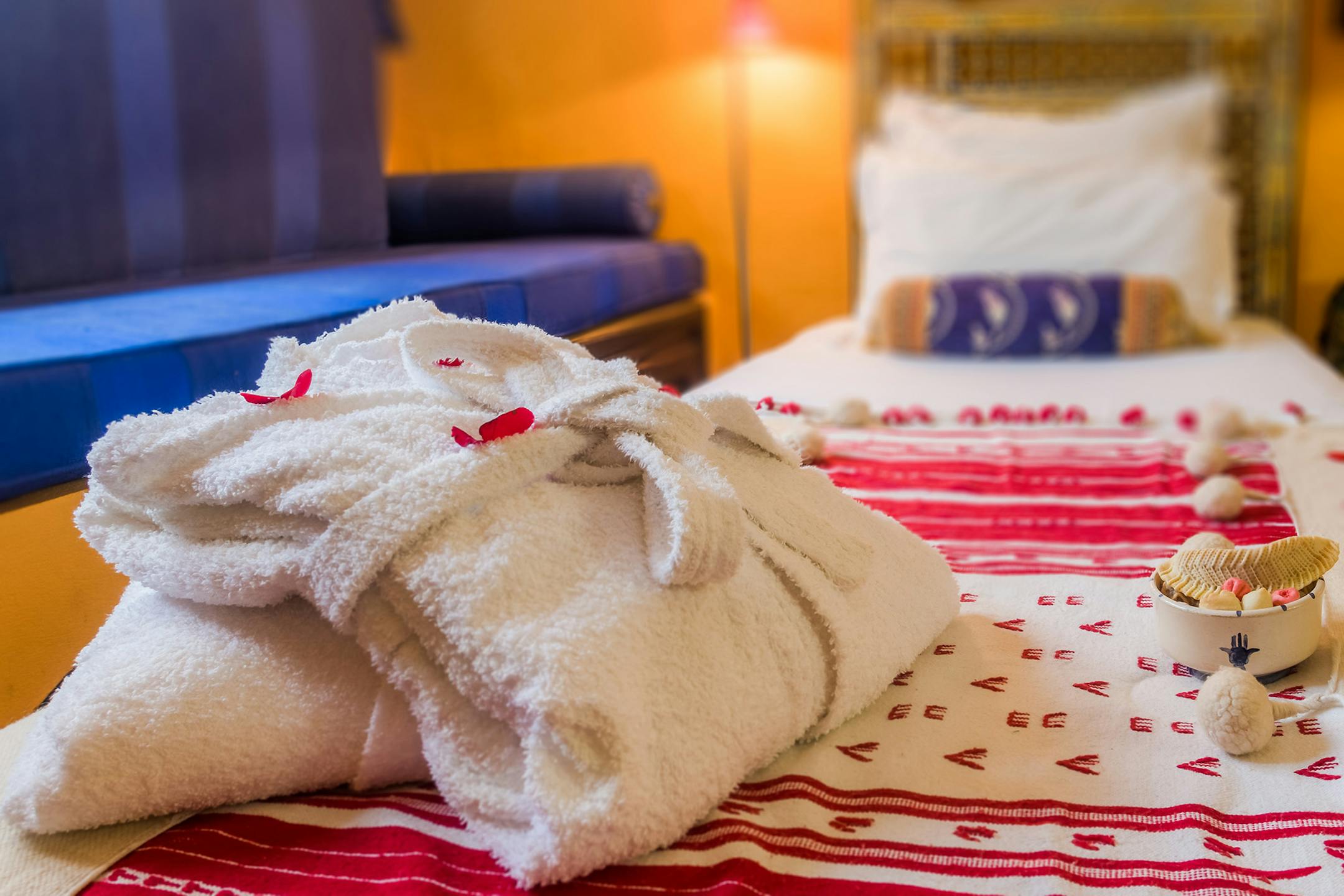Moroccan hotel bedroom with dressing gown and snacks