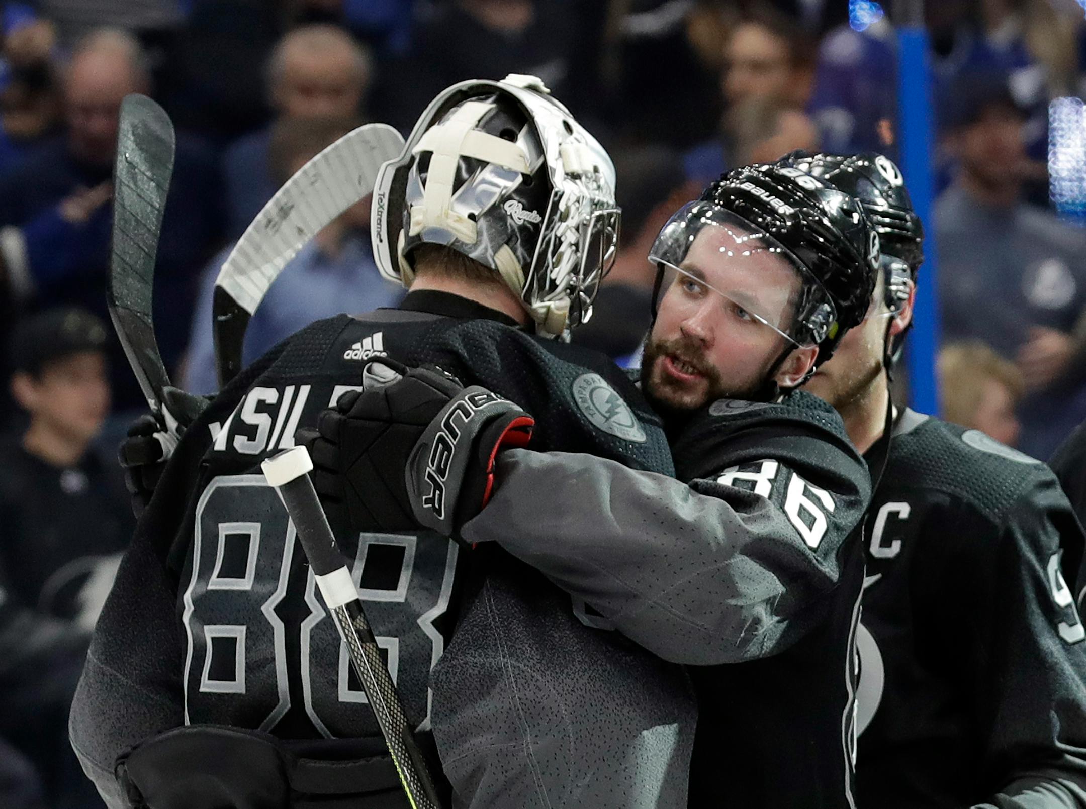 Tampa Bay Lightning right wing Nikita Kucherov (86) hugs goaltender Andrei Vasilevskiy (88) after the Lightning defeated the Ottawa Senators 5-1 during an NHL hockey game Saturday, March 2, 2019, in Tampa, Fla. (AP Photo/Chris O'Meara)