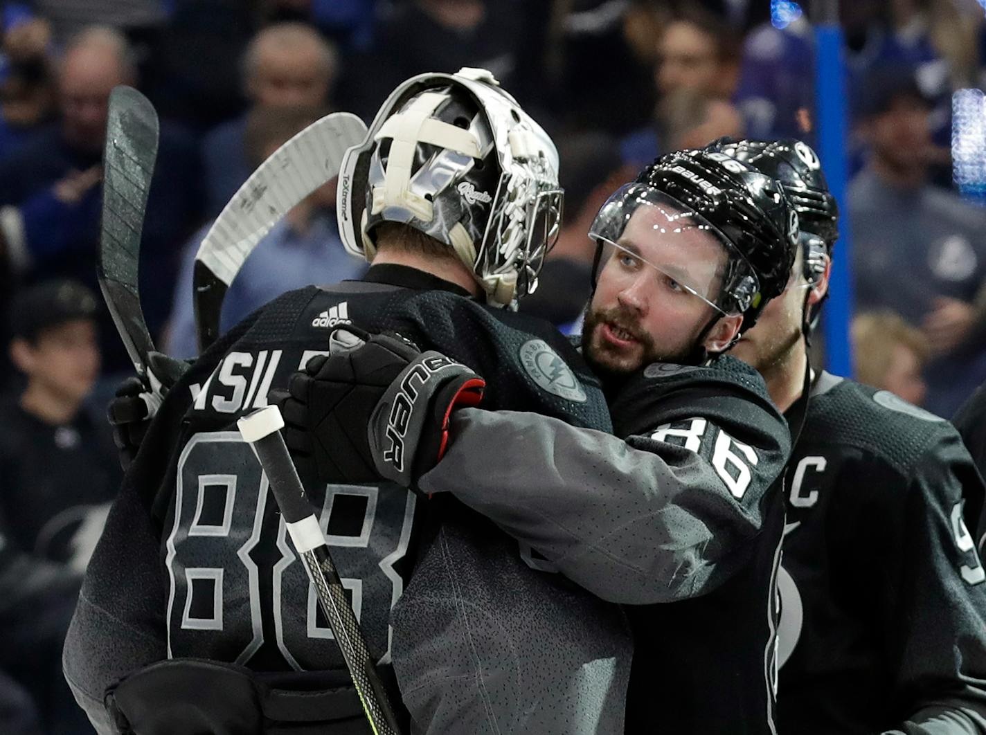 Tampa Bay Lightning right wing Nikita Kucherov (86) hugs goaltender Andrei Vasilevskiy (88) after the Lightning defeated the Ottawa Senators 5-1 during an NHL hockey game Saturday, March 2, 2019, in Tampa, Fla. (AP Photo/Chris O'Meara)