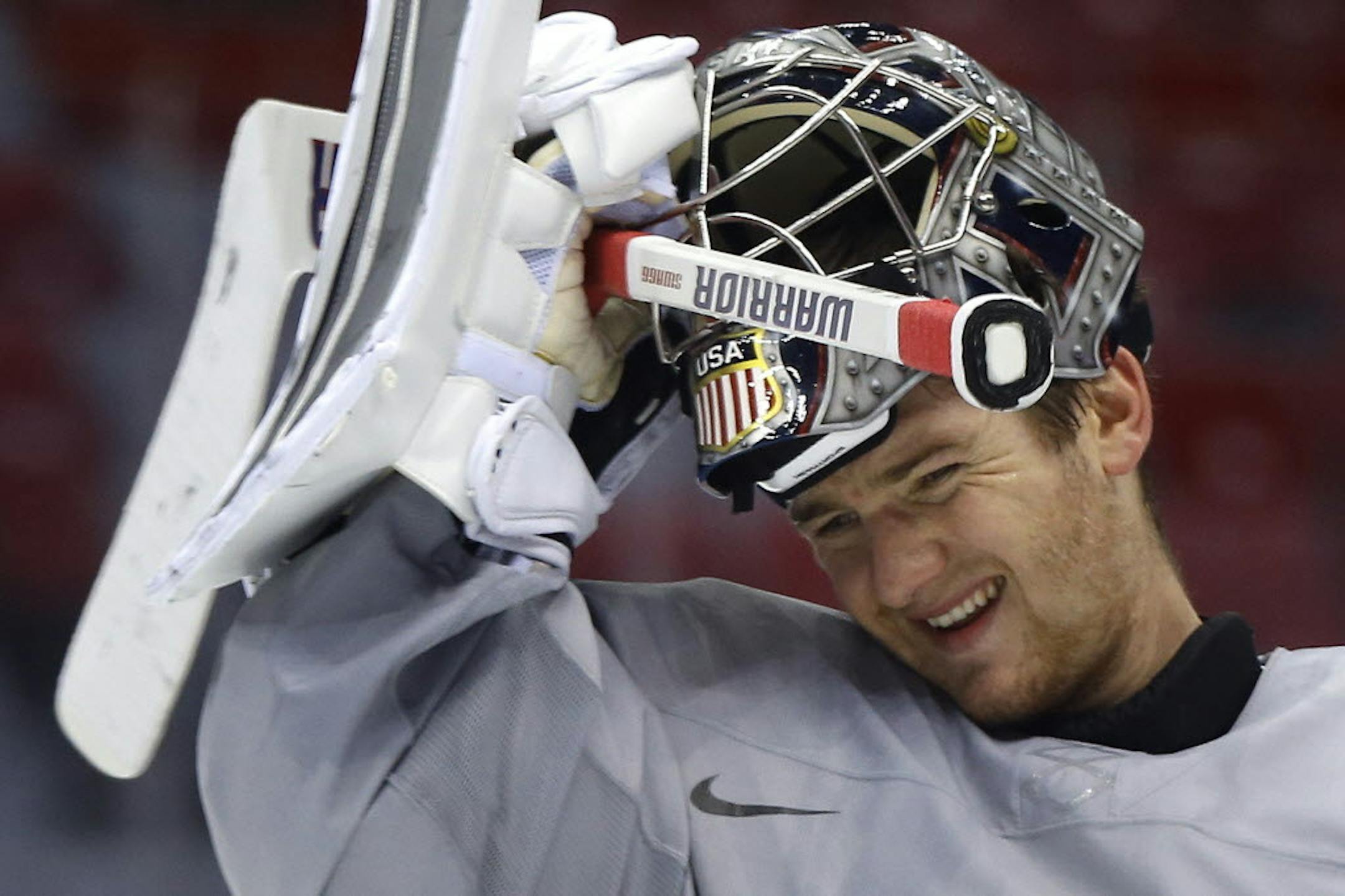 USA goaltender Jonathan Quick pulls his helmet down during a training session at the 2014 Winter Olympics, Monday, Feb. 10, 2014, in Sochi, Russia.