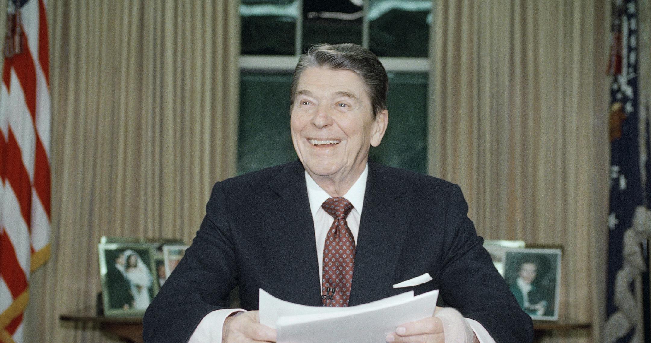 President Ronald Reagan poses for photographers in the Oval Office of the White House, Jan. 11, 1989 after delivering a televised farewell address to the nation. In the parting address, Reagan said that during his eight years in office, "we meant to change a nation and instead we changed a world." (AP Photo/Ron Edmonds) ORG XMIT: APHS208286