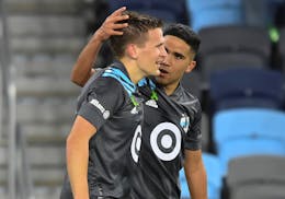Loons midfielder Emanuel Reynoso (10) celebrated with midfielder Robin Lod (17) after Lod's game-winning goal May 15 against FC Dallas.