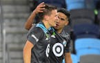 Loons midfielder Emanuel Reynoso (10) celebrated with midfielder Robin Lod (17) after Lod's game-winning goal May 15 against FC Dallas.