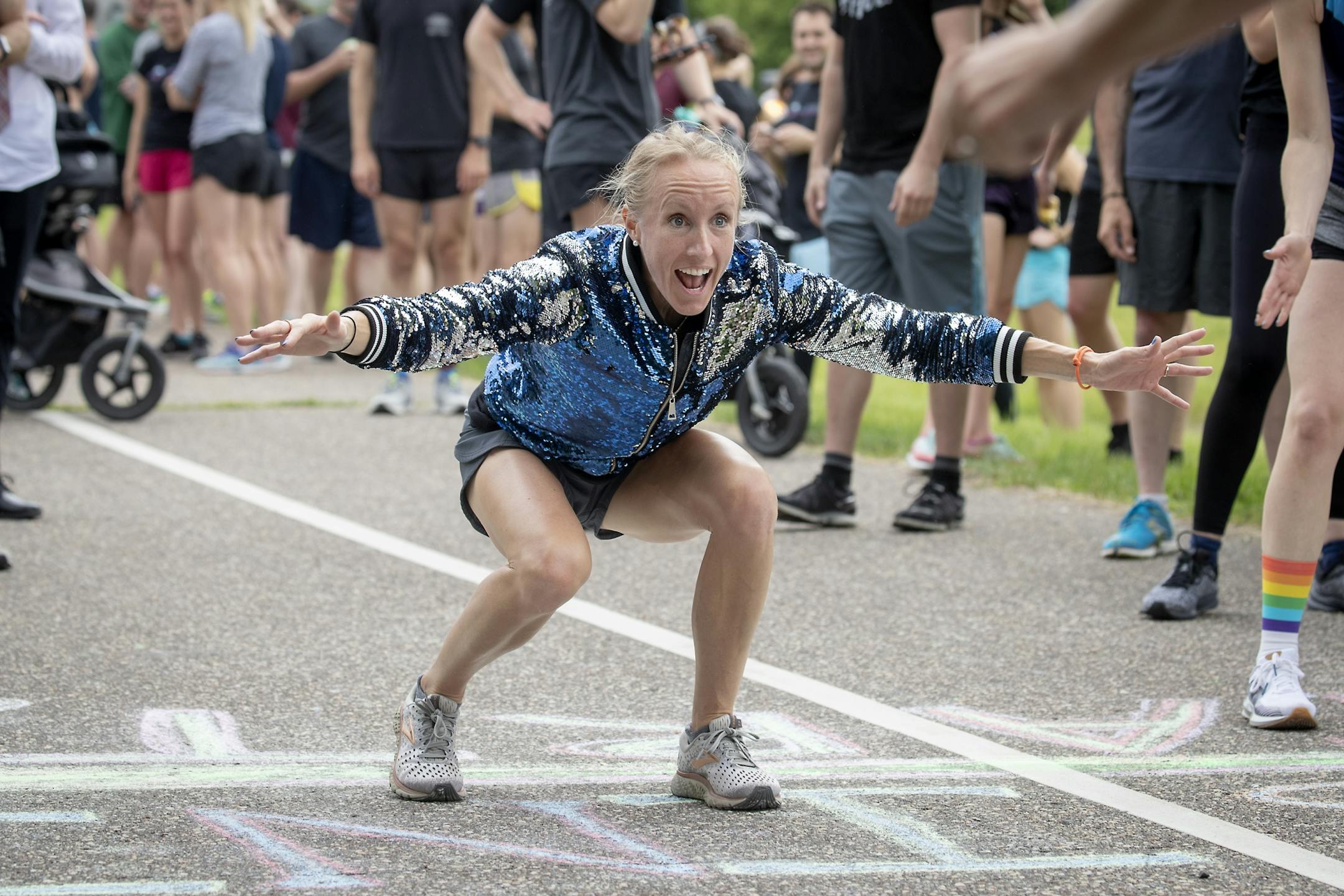 Gabriele Grunewald's running teammate and best friend Ladia Albertsonb-Junkans greeted family, friends, and supporters after they crossed the finish line following a one-mile run/jog/walk in honor Gabriele just outside Hillside Cemetery.