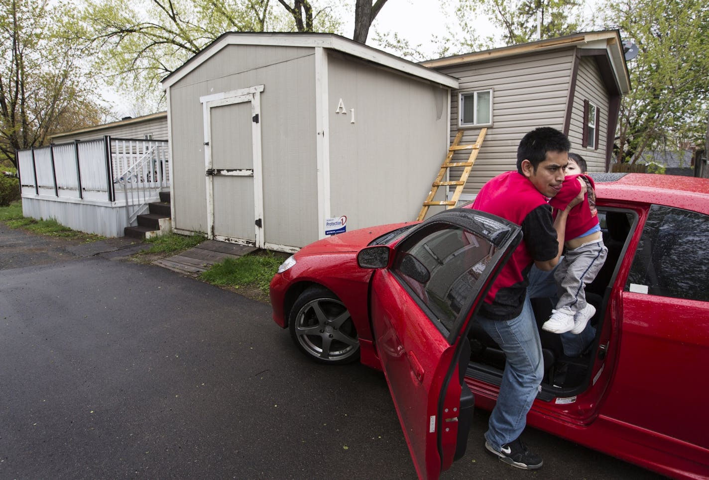 Fabian Segarra gets out of the car with his 14-month-old son Steben.