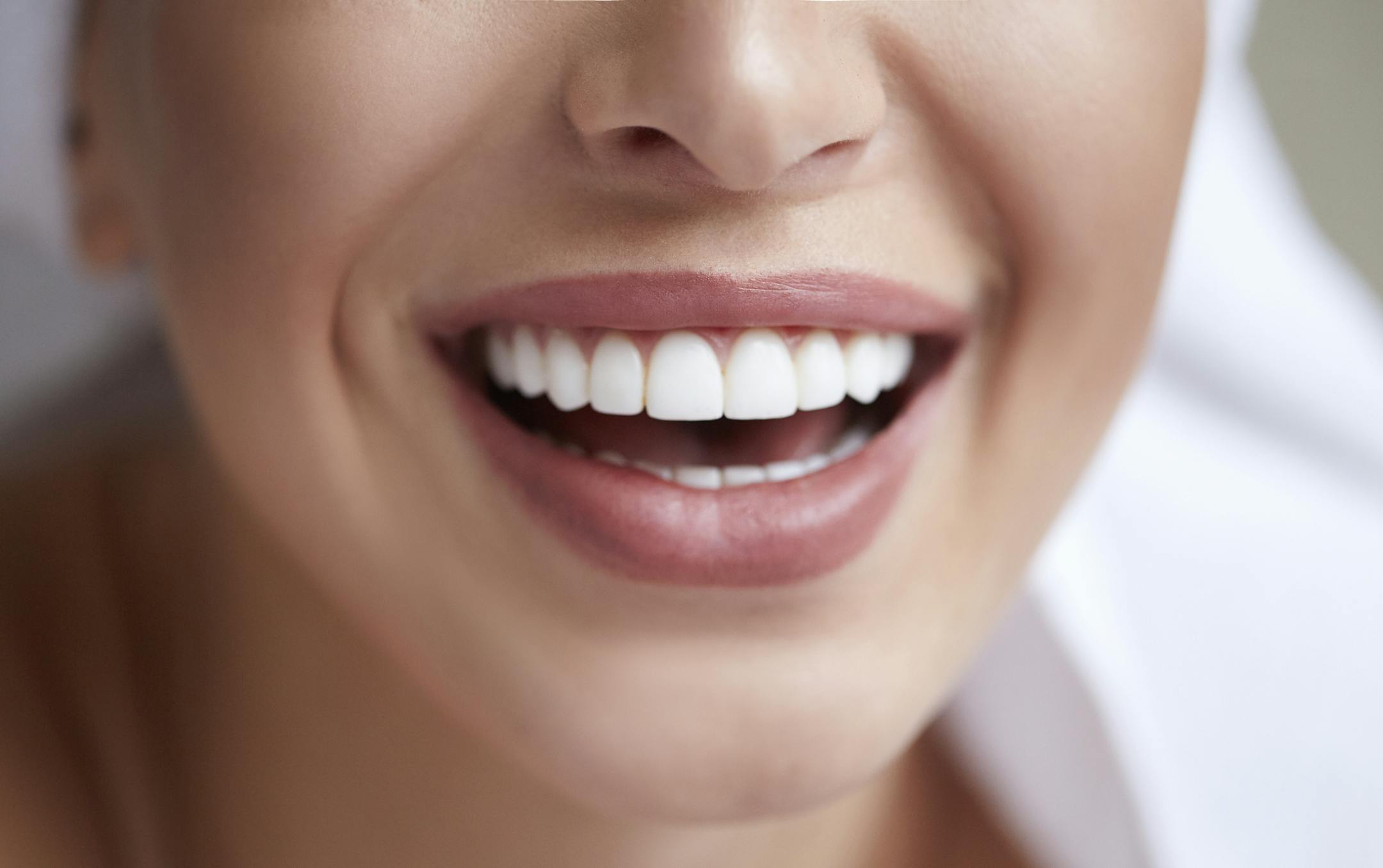 Healthy white smile close up. Beauty woman with perfect smile, lips and teeth. Beautiful Model Girl with perfect skin. Teeth whitening.