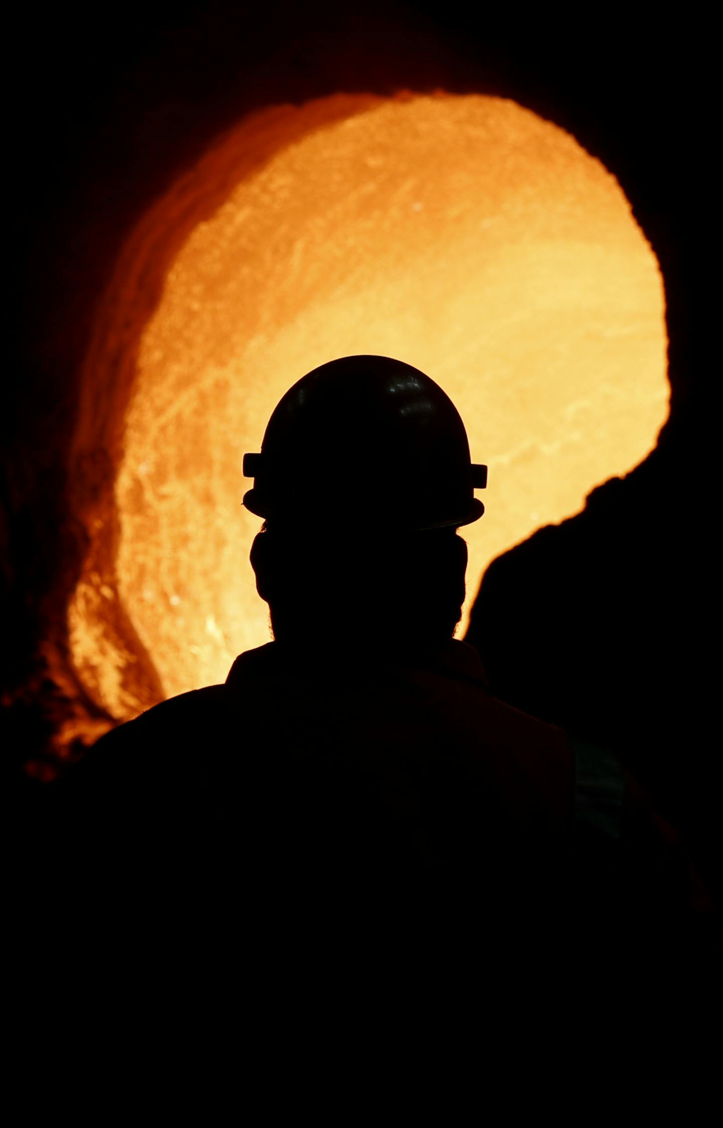 Senior melt operator Randy Feltmeyer examines a giant ladle after dumping its contents of red-hot iron used in the production of steel at the U.S. Steel Granite City Works facility, Thursday, June 28, 2018, in Granite City, Ill. (AP Photo/Jeff Roberson) ORG XMIT: ILJR104