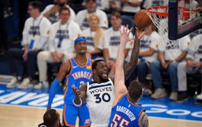 Timberwolves forward Julius Randle (30) scores as Oklahoma City Thunder center Isaiah Hartenstein (55) defends in the third quarter.