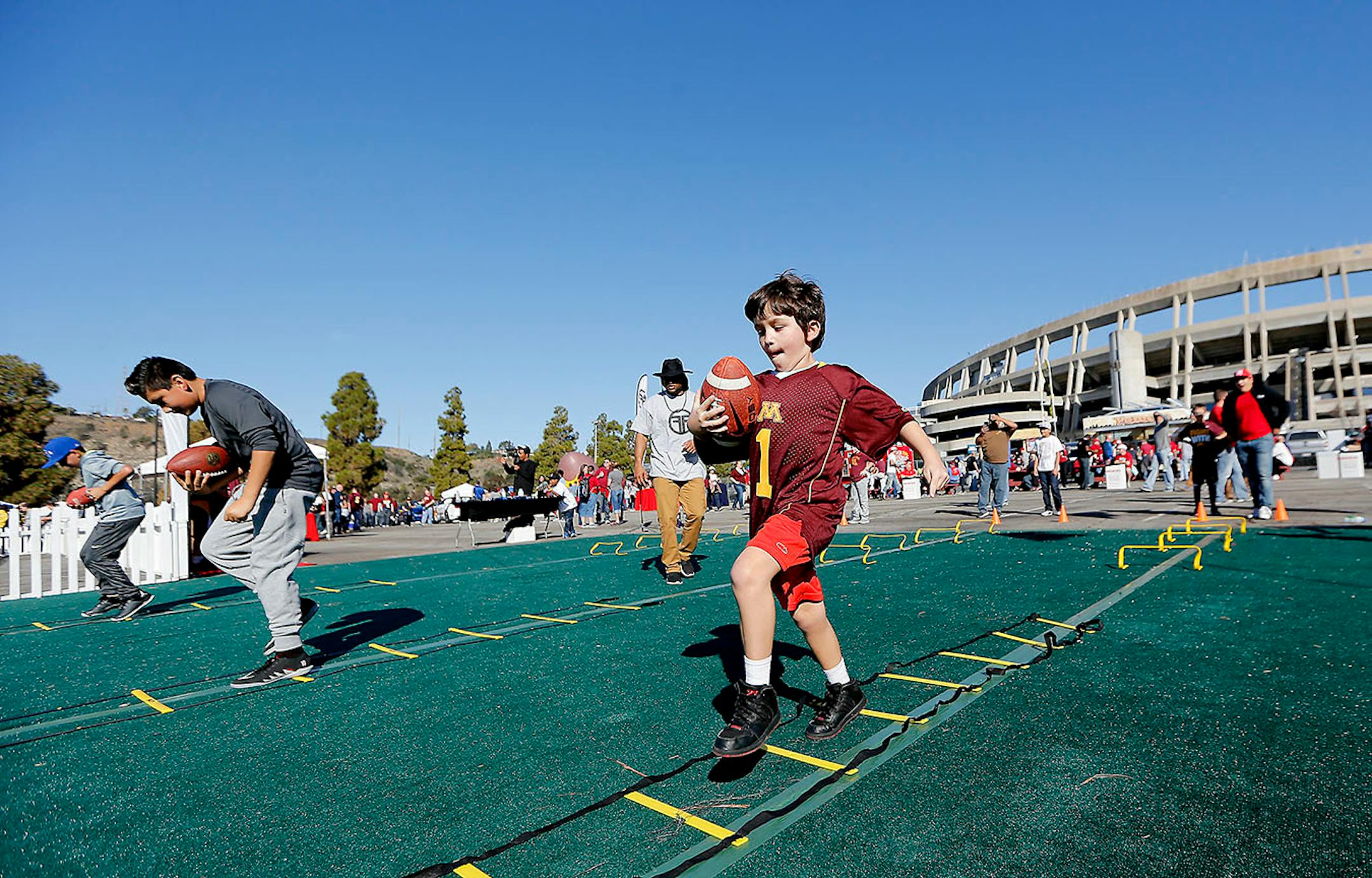 Daniel O'Shae-Segura, 7, who was there with his father Larry O'Shae of Inver Grove Heights, MN, tested his football skills at the fan zone area at Qualcomm Stadium during the San Diego Holiday Bowl, Tuesday, December 27, 2016 in San Diego, CA.