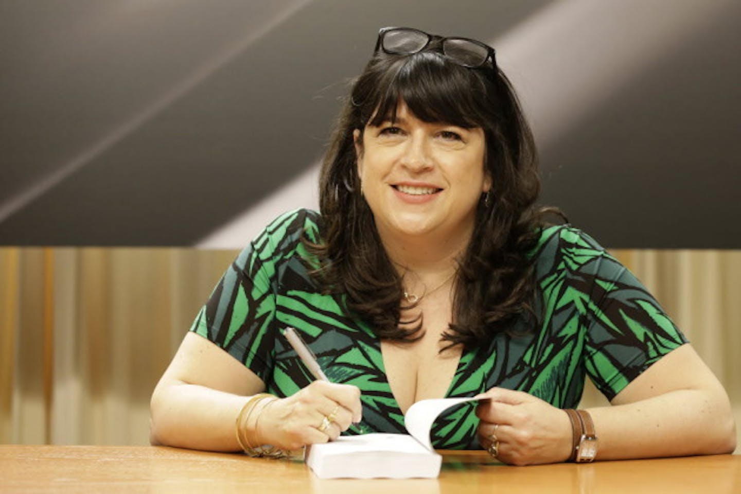 E.L. James, signing copies of "Grey." Associated Press photo by Mary Altaffer