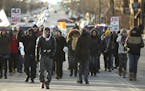 Alexander Clark, center, a cousin of Jamar Clark, led demonstrators as they marched on the Lake St. bridge to meet their St. Paul counterparts Monday 