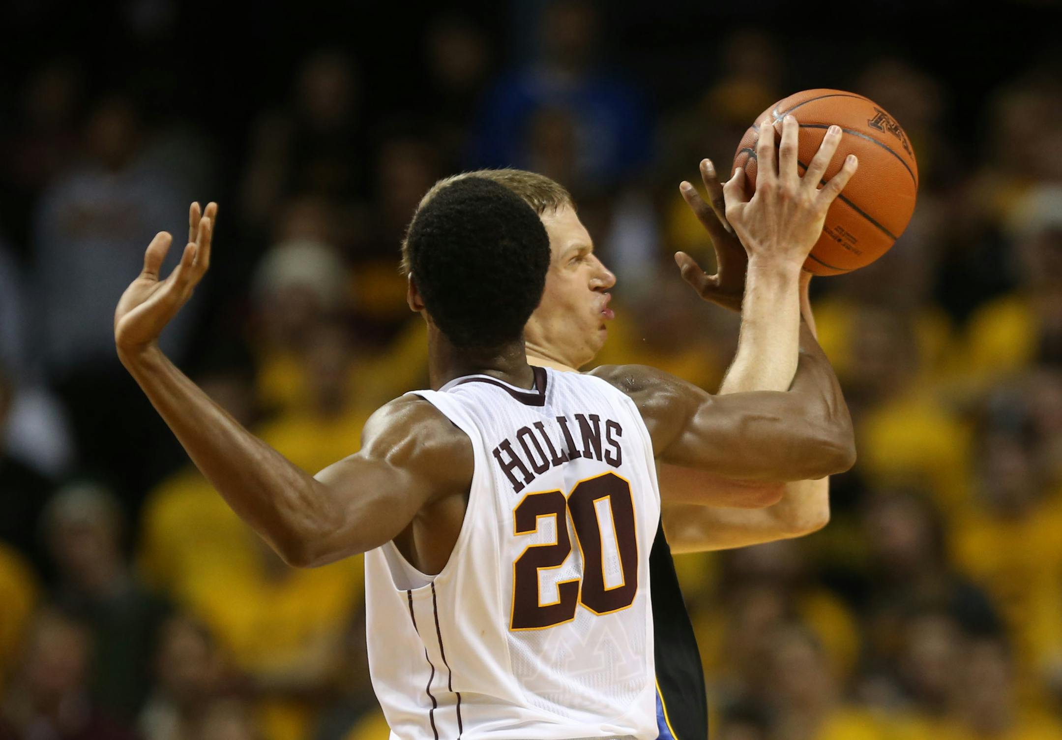 Austin Hollins tried to strip the ball from South Dakota State's Marcus Heemstra during the first half at Williams Arena in Minneapolis Tuesday, December 10, 2013.