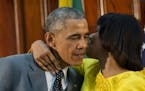 Jamaican Prime Minister Portia Simpson-Miller hugs President Barack Obama following the conclusion of their bilateral meeting at the Jamaica House, Th