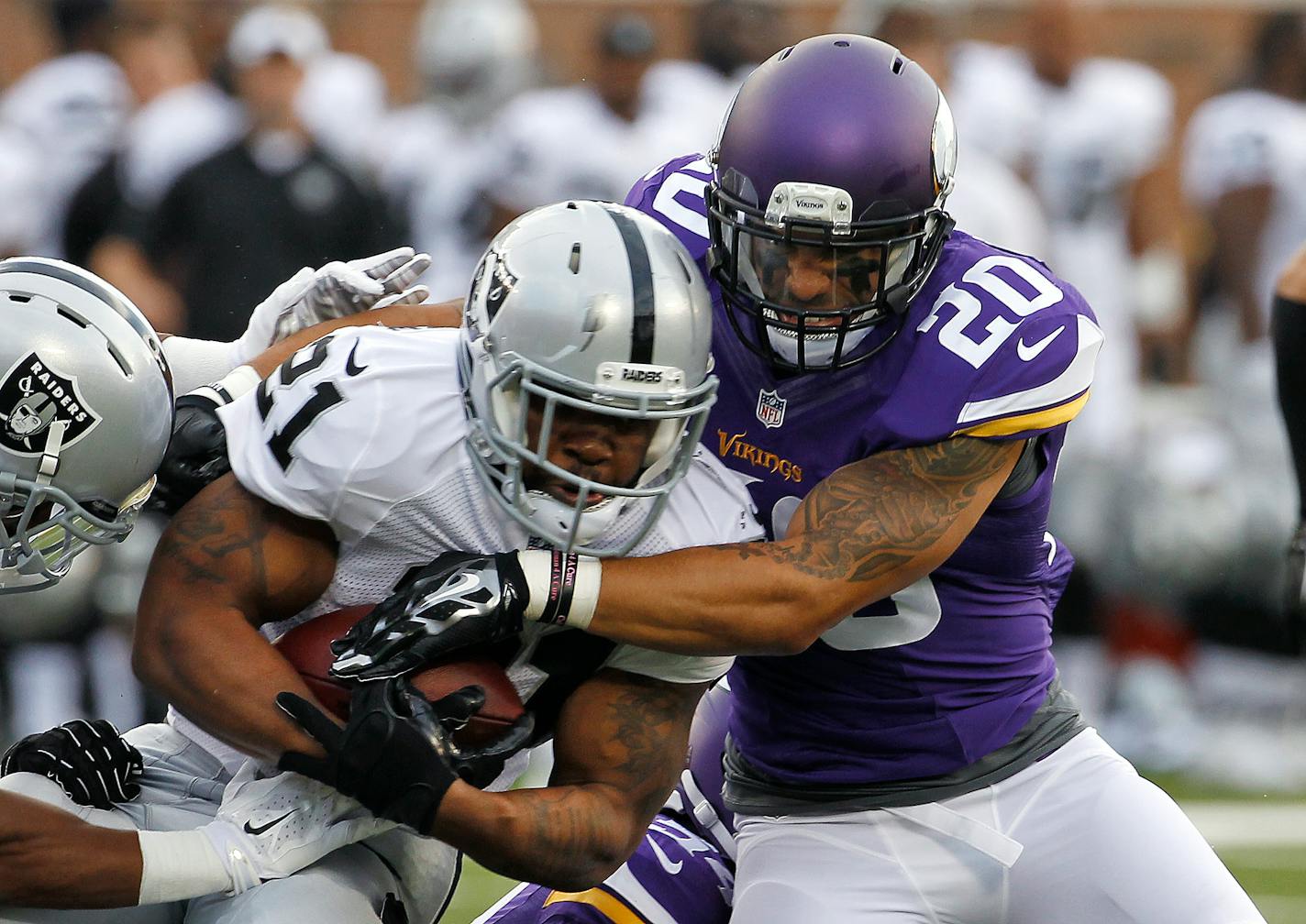 Oakland Raiders running back Maurice Jones-Drew (21) is wrapped up by Minnesota Vikings free safety Kurt Coleman (20) in the first half of a preseason NFL football game at TCF Bank Stadium in Minneapolis, Friday, Aug. 8, 2014. (AP Photo/Ann Heisenfelt)