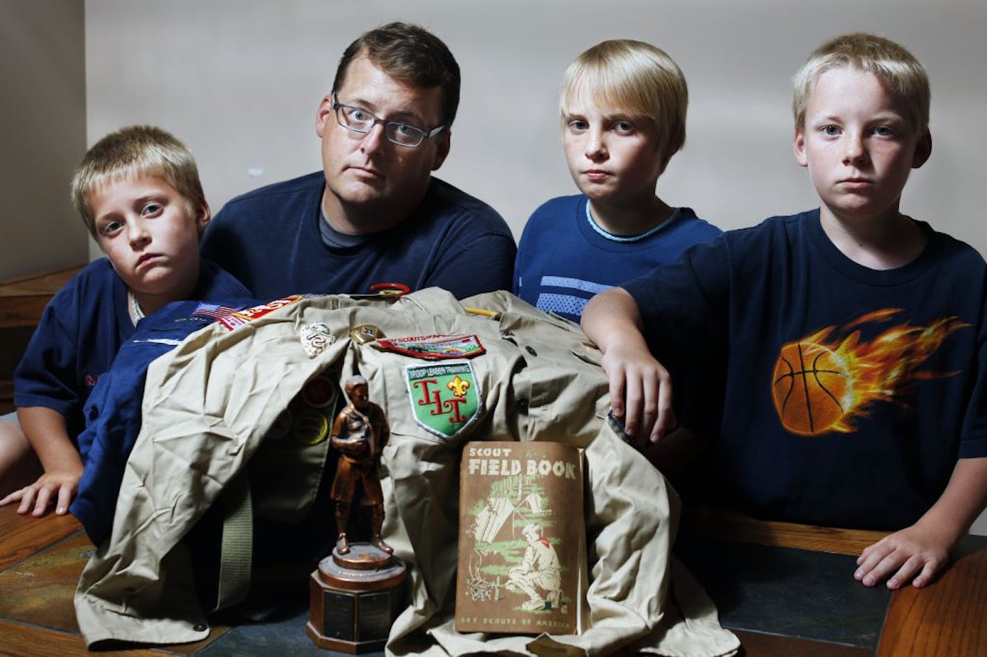 Ira Mitchell has previously kept his sons, from left, Asher, 8, Field, 12, and Owen, 9, from joining the Boy Scouts because "my kids are not going to be in an organization that discriminates against gay people." The Northern Star Council's stand has him reconsidering his position, though.