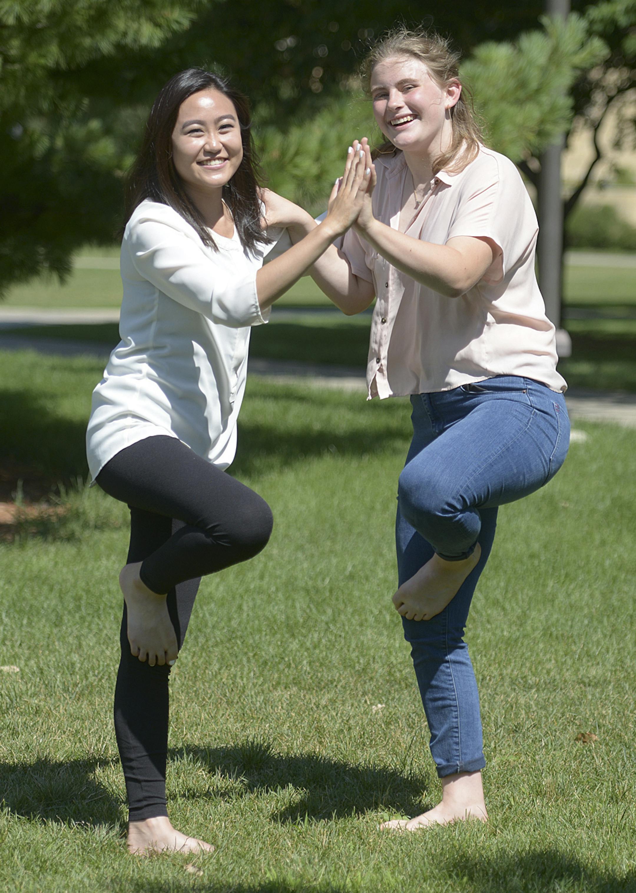 Danielle Wong, 17, left, and Julia Larson, 17, showed off their yoga moves in July at the University of St. Thomas. They are two of many young people across the country who have taken up the popular ancient Indian disciple. (Photo courtesy of Mark Vancleave)