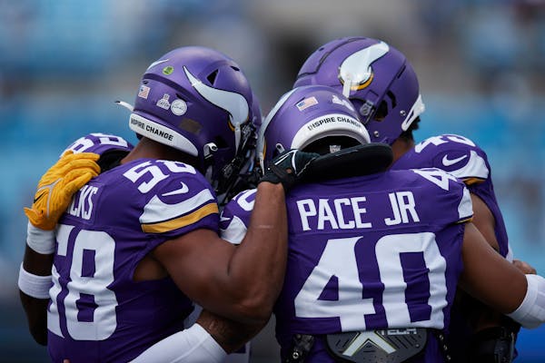 Vikings linebacker Jordan Hicks, left, usually wears the green dot on his helmet, meaning he receives defensive signals from coaches. Rookie Ivan Pace