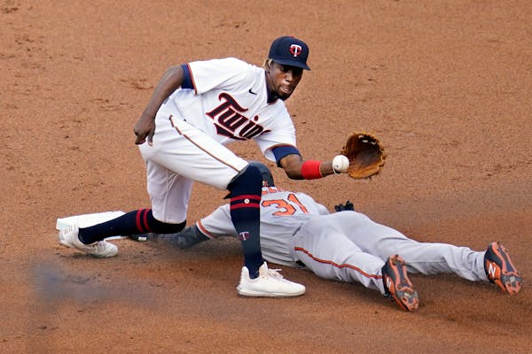 Cedric Mullins of the Orioles beat a throw to Twins second baseman Nick Gordon on May 24 at Target Field.