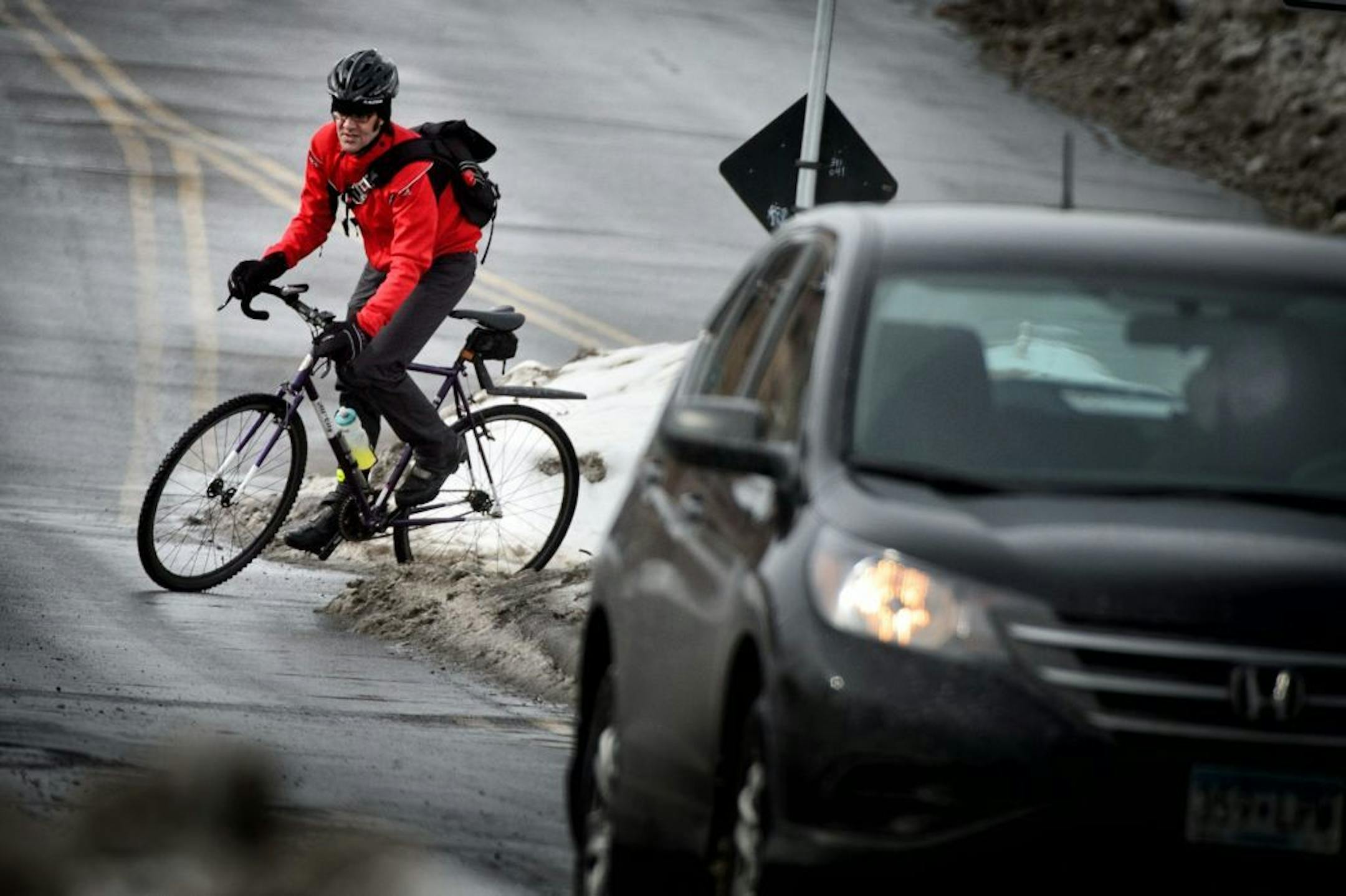 Bicyclists ride along Midtown Greenway where it intersects with 28th Street E in Minneapolis. Tuesday, February 18, 2014