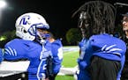 Minneapolis North quarterback Deshaun Hill, right, shook a teammate’s hand after winning a game against SMB Wolfpack in September 2021.