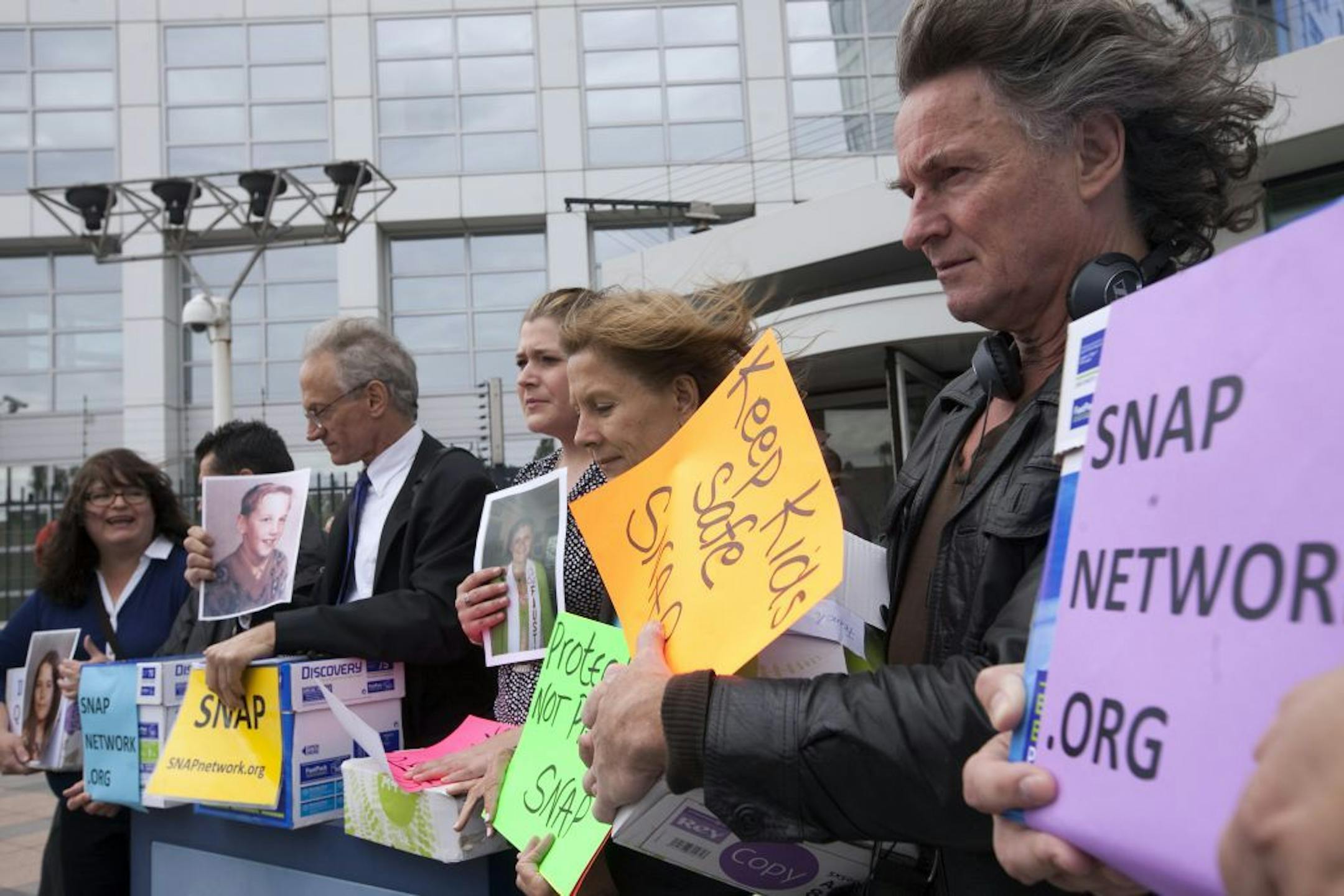 Members of Survivors Network of those Abused by Priests (SNAP), from left: Rita Milla, Emmanuel Henckens, Phil Saviano, Megan Peterson, Barbara Blaine and Bert Smeets, pose in front of the International Criminal Court (ICC) in The Hague, Netherlands, Tuesday, Sept. 13, 2011.