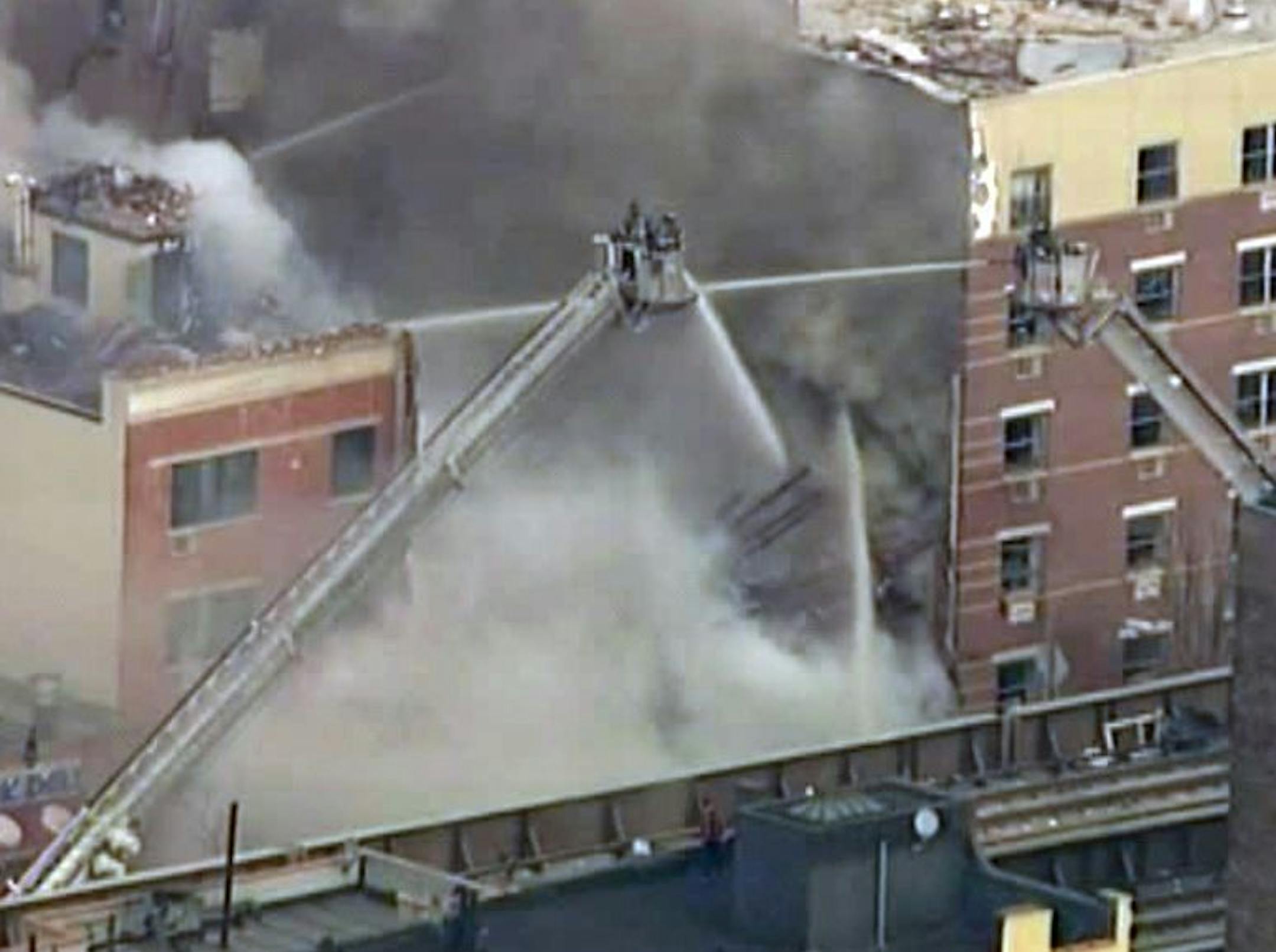 In this image taken from video from WABC, firefighters battle a blaze at the site of a possible explosion and building collapse in the East Harlem neighborhood of New York, Wednesday, March 12, 2014.