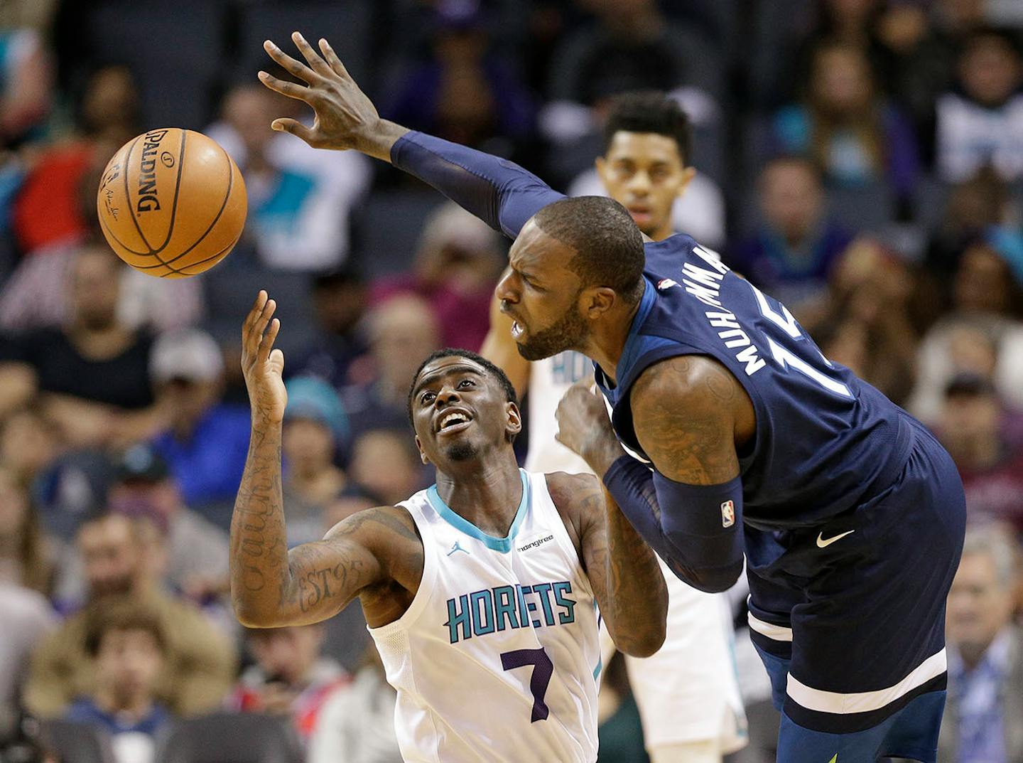 Charlotte Hornets' Dwayne Bacon (7) and Minnesota Timberwolves' Shabazz Muhammad (15) battle for a loose ball during the first half of an NBA basketball game in Charlotte, N.C., Monday, Nov. 20, 2017.