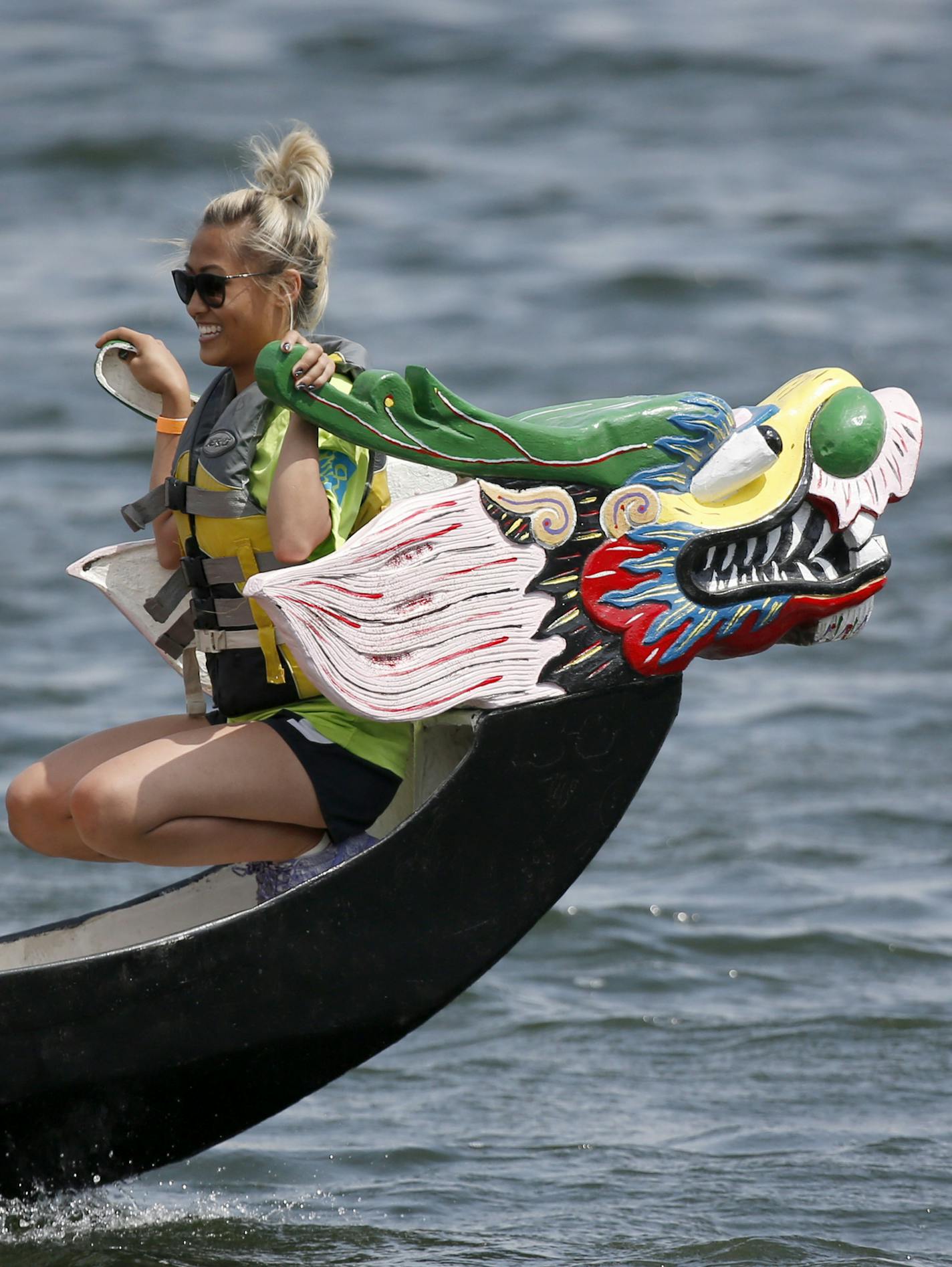 Chu Thao of the Blue Wave Cruisers smiled after winning their race on Lake Phalen. ] (KYNDELL HARKNESS/STAR TRIBUNE) kyndell.harkness@startribune.com Dragon Festival in St Paul, Min., Saturday, July 10, 2015.