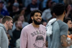 Karl-Anthony Towns was on the bench but not in uniform when the Timberwolves played on Saturday night in Sacramento.