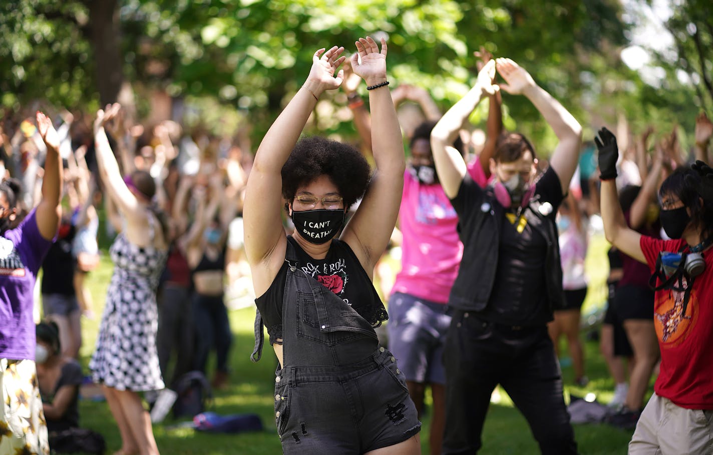 Chris Rame, 18, a hip-hop dance teacher, practiced yoga in Loring Park after marching through downtown Minneapolis.