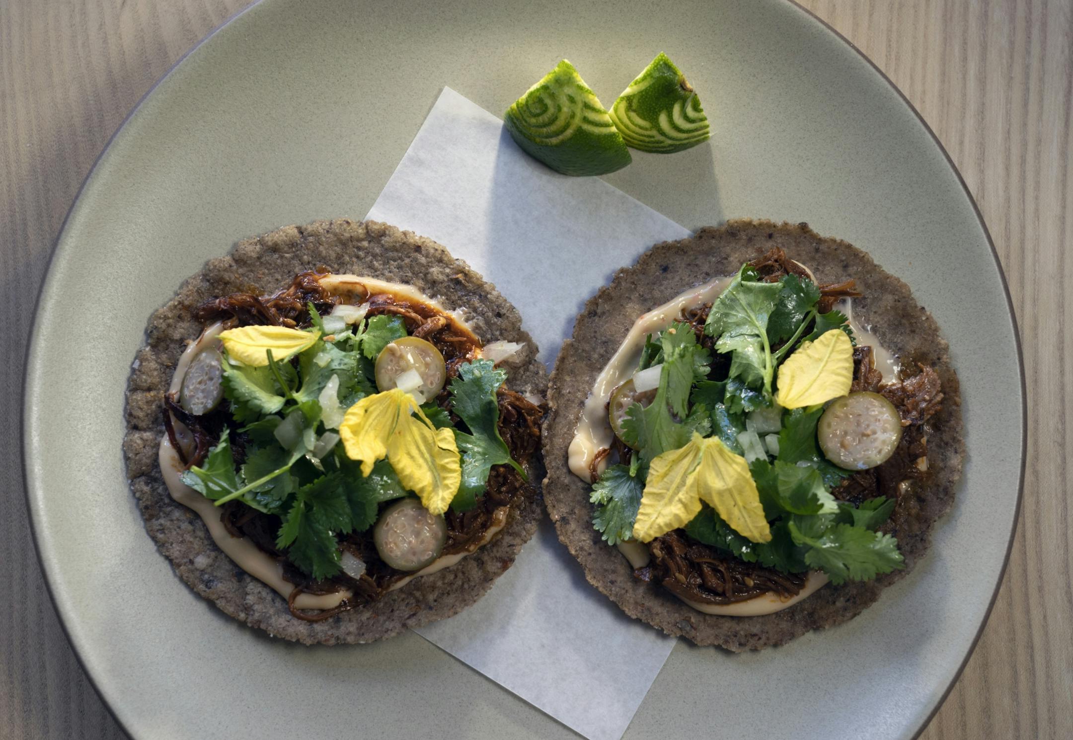 Lamb Barbacoa Tacos anchovy, caper berries, onions, cilantro.