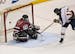 Hermantown's Ryan Carlson scored on New Prague goalie Connor Wagner in the first period during the State Boys hockey Tournament 1A semifinals between 
