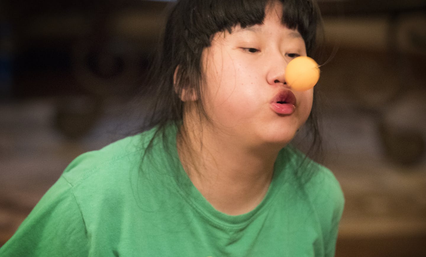 Pahnuly Xiong plays around with the Aeropong ball by blowing on it. ] LEILA NAVIDI &#xef; leila.navidi@startribune.com BACKGROUND INFORMATION: At home with the Xiong family in Brooklyn Park on Tuesday, January 9, 2018. Fifth grader Kusa Xiong wanted to find a way for his autistic sister to play and enjoy his favorite game: ping pong. Known as a kid inventor, Xiong ended up creating an entirely new, ping pong-style toy called Aeropong. His idea has captured national accolades in a contest and wil