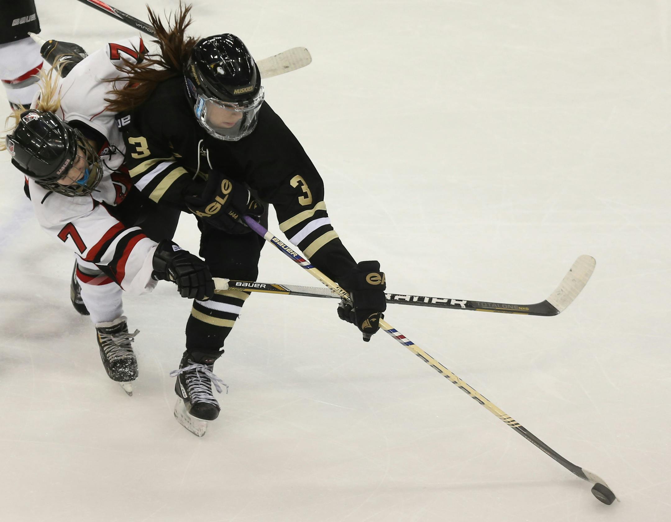 Andover's McKenzie SederBerg and Eden Prairie's Angie Heppelmann fought over the puck during the first period of the 2A quarterfinals at Xcel Energy Center in St. Paul Thursday, February 20, 2014. Eden Prairie won over Andover 4-2. ] (KYNDELL HARKNESS/STAR TRIBUNE) kyndell.harkness@startribune.com