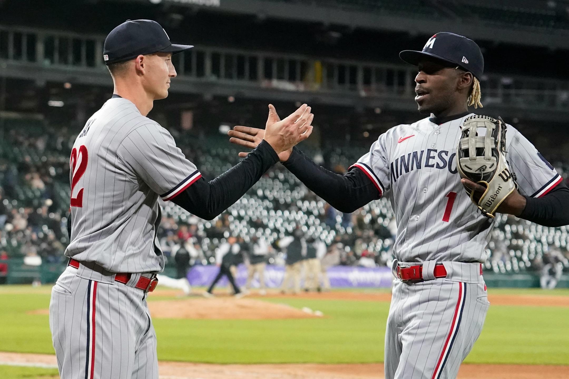 Minnesota Twins relief pitcher Griffin Jax, left, congratulates Nick Gordon after Gordon chased down a deep fly ball by Chicago White Sox's Andrew Benintendi in the eighth inning of a baseball game on Tuesday, May 2, 2023, in Chicago. (AP Photo/Charles Rex Arbogast)