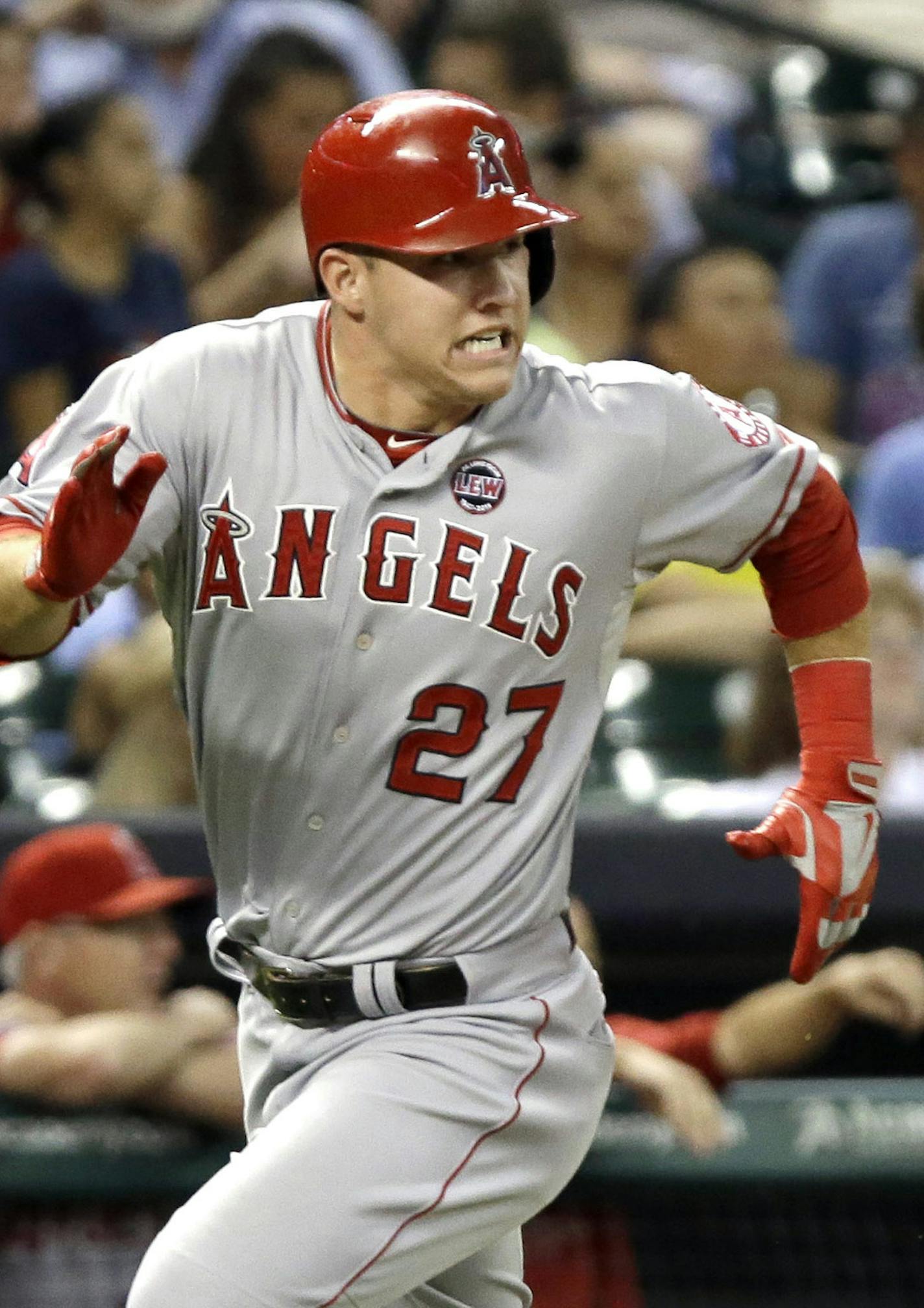 Los Angeles Angels' Mike Trout races toward home plate to score on a Mark Trumbo two-run triple against the Houston Astros in the third inning of a baseball game Friday, Sept. 13, 2013, in Houston. (AP Photo/Pat Sullivan)