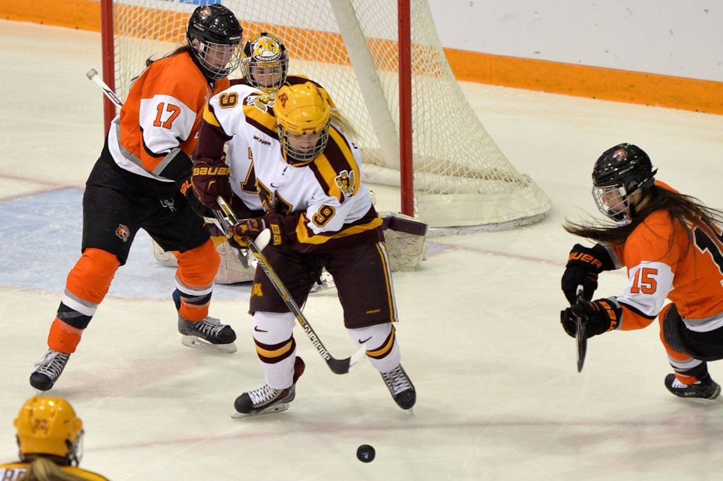 Minnesota's Sydney Baldwin looks to clear the puck from Gopher territory with pressure from RIT's Carly Payerl and Kolbee McCrea during the first period of the NCAA quarterfinal game Saturday, March 14 at the University of Minnesota's Ridder Arena. Minnesota led RIT, 3-1 at the end of the period.