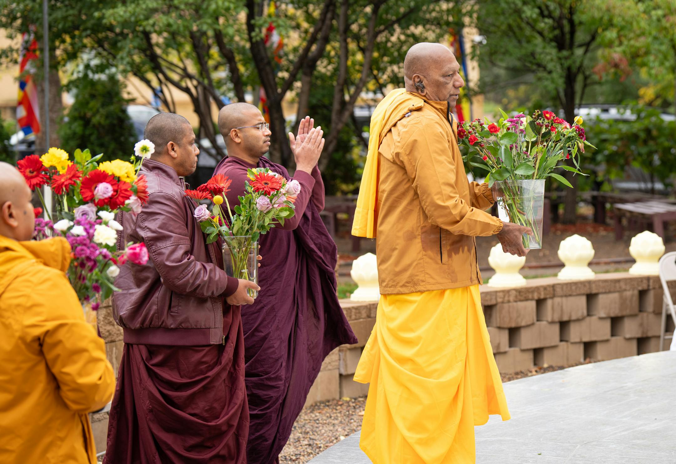 Visiting monks brought flowers to be placed on the Stupa Friday.