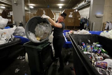 Heidi Riley dumped plastic into a recycling bin after the game at US Bank Stadium.