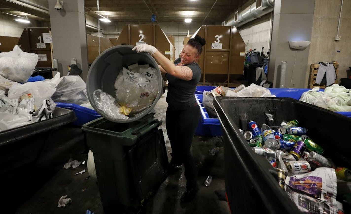 Heidi Riley dumped plastic into a recycling bin after the game at US Bank Stadium.