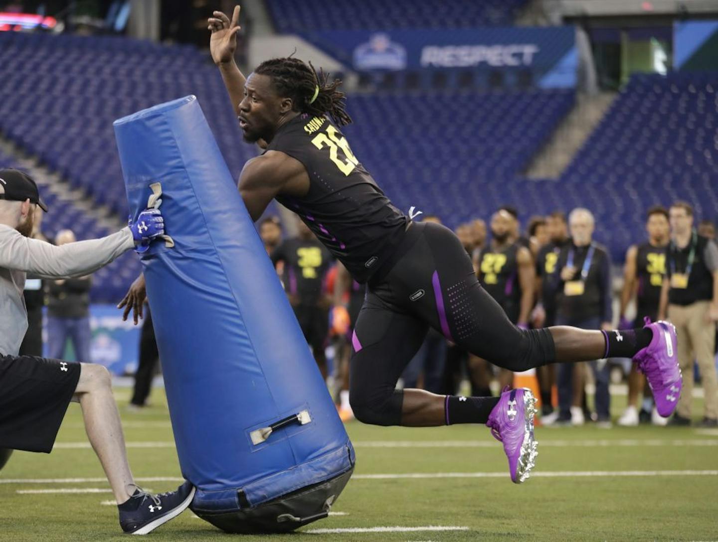 Tulane defensive lineman Ade Aruna runs a drill at the NFL football scouting combine in Indianapolis, Sunday, March 4, 2018.