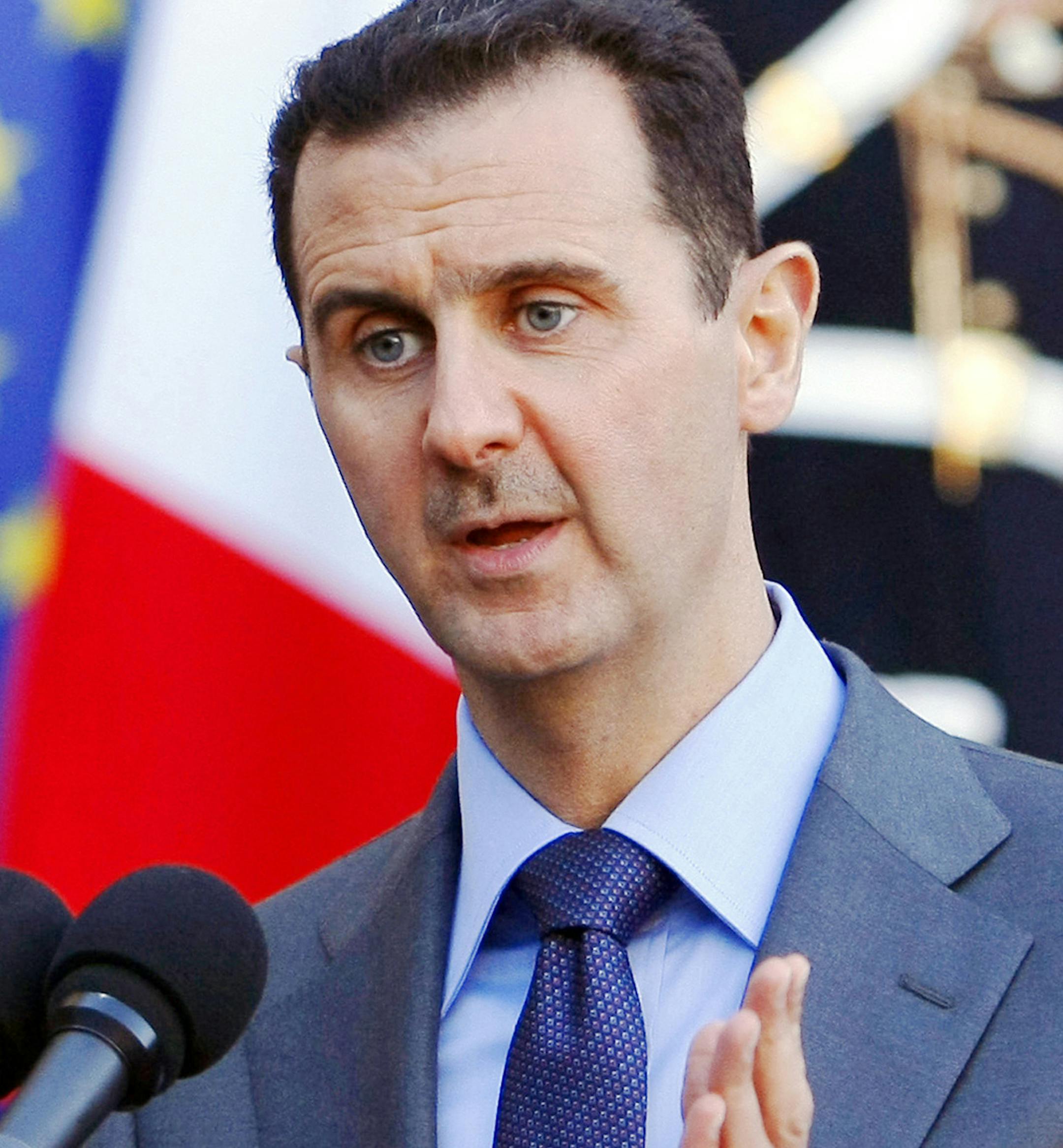 FILE - In this Thursday Dec. 9, 2010 file photo, Syria President Bashar al-Assad addresses reporters following his meeting with French President Nicolas Sarkozy at the Elysee Palace in Paris, France. Paris prosecutors have opened a preliminary investigation into French government accusations that Syrian President Bashar Assad's government has committed crimes against humanity. The prosecutor's office said Wednesday the investigation is based on photos taken by a former Syrian officer who fled in
