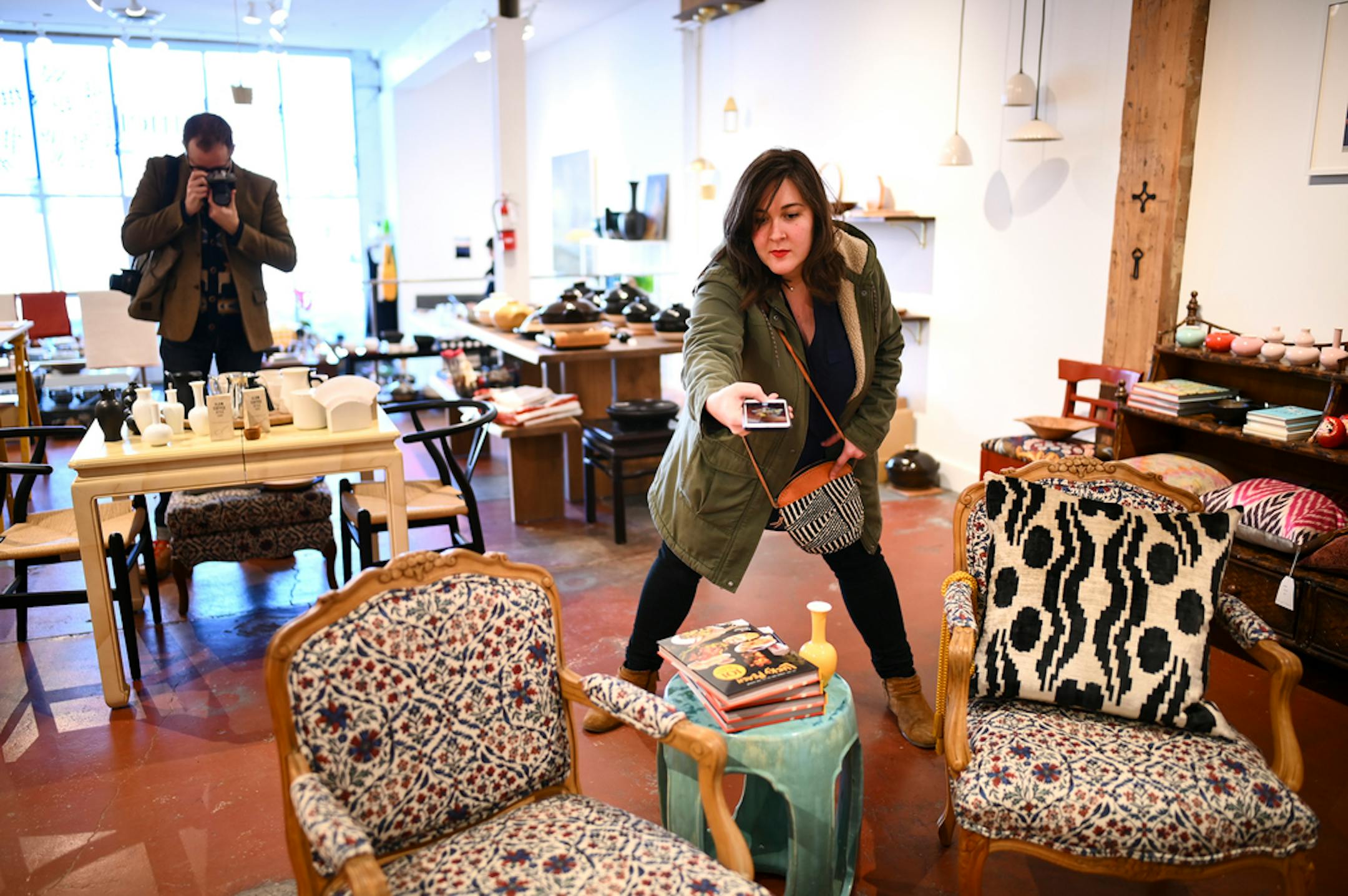 Ashlea Halpern did her best to keep her shadow out of a photo while Andrew Park took photos behind her as they visited and documented Umei in north Minneapolis Thursday. ] Aaron Lavinsky ¥ aaron.lavinsky@startribune.com Ashlea Halpern and her partner Andrew Park are travel writers for major national magazines. After living all over the world, they decided to move back to the U.S. Guided by an elaborate spreadsheet, they embarked on a yearlong road trip to check out 229 cities and towns before se