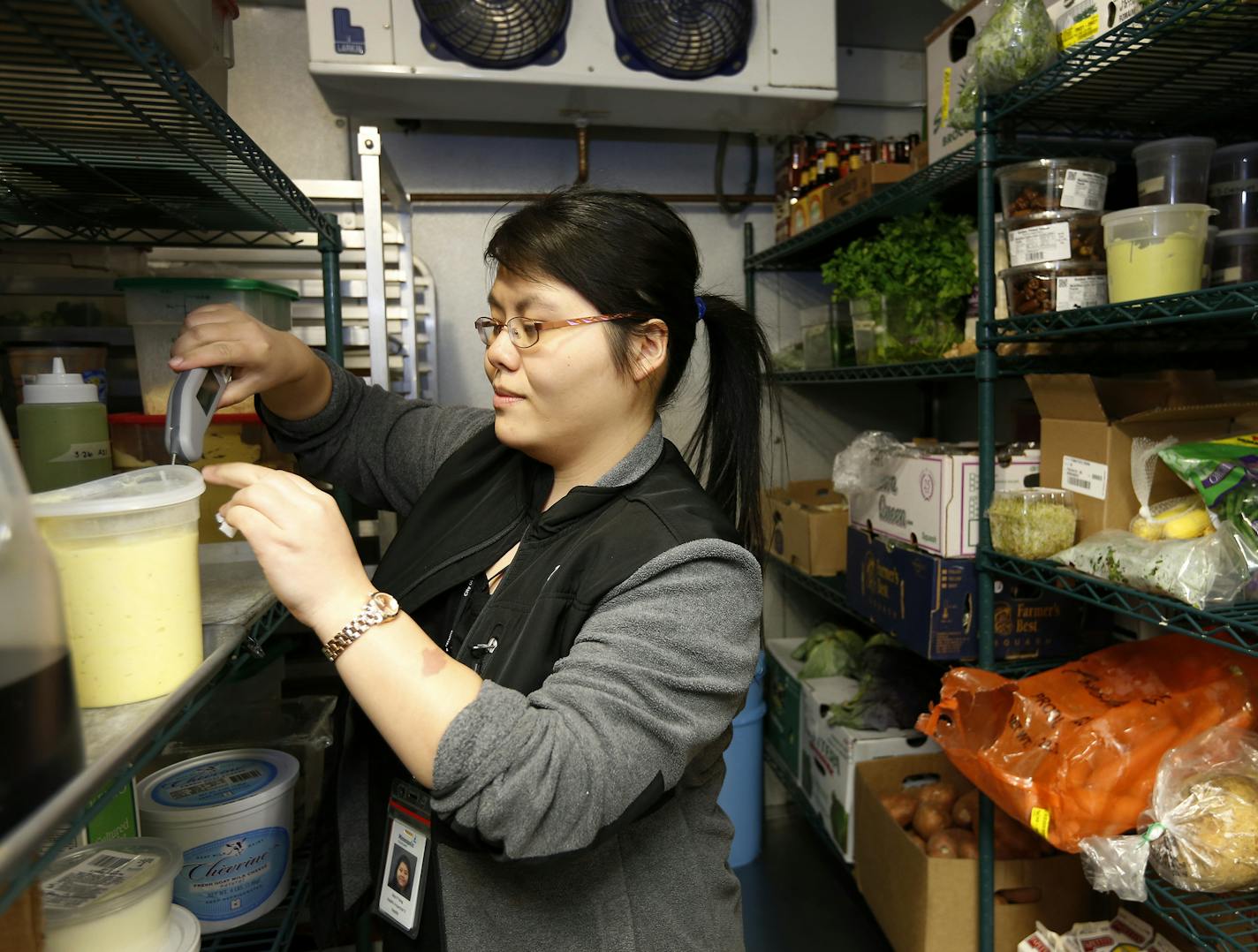 Minneapolis health inspector Mai P. Yang checked the temperature inside of the walk in cooler at the Sassy Spoon in Minneapolis. ] CARLOS GONZALEZ cgonzalez@startribune.com - April 5, 2016, Minneapolis, MN, A restaurateur at the Sassy Spoon, along with a city inspector, will show us the inside of a walk-in restaurant cooler -- and some of the techniques for cooling. Cooling food properly is one of the most important factors for avoiding foodborne illness. Food temperatures are among a number of