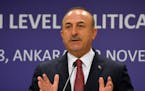 Turkish Foreign Minister Mevlut Cavusoglu speaks in a joint press conference with the European Union's High Representative for Foreign Affairs and Sec