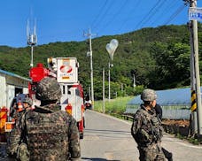 FILE - In this photo provided by Jeonbuk Fire Headquarters, balloons with trash presumably sent by North Korea, hang on electric wires as South Korean