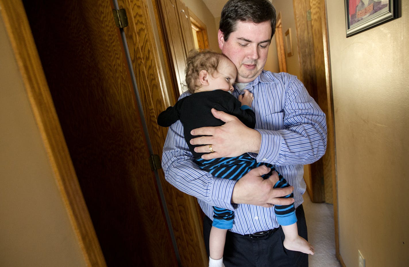 Keith Cushman carries one of his twin 18-month-old sons out of the bedroom after a nap as they wait for his other two children (not twins) to get home from middle school in Cologne, MN, January 2, 2014. (Courtney Perry/Special to the Star Tribune) ] *Keith's wife didn't want to be pictured, and she doesn't want the names of their children in the paper.